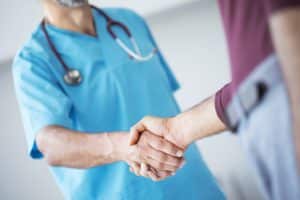 Doctor shakes hands with a patient