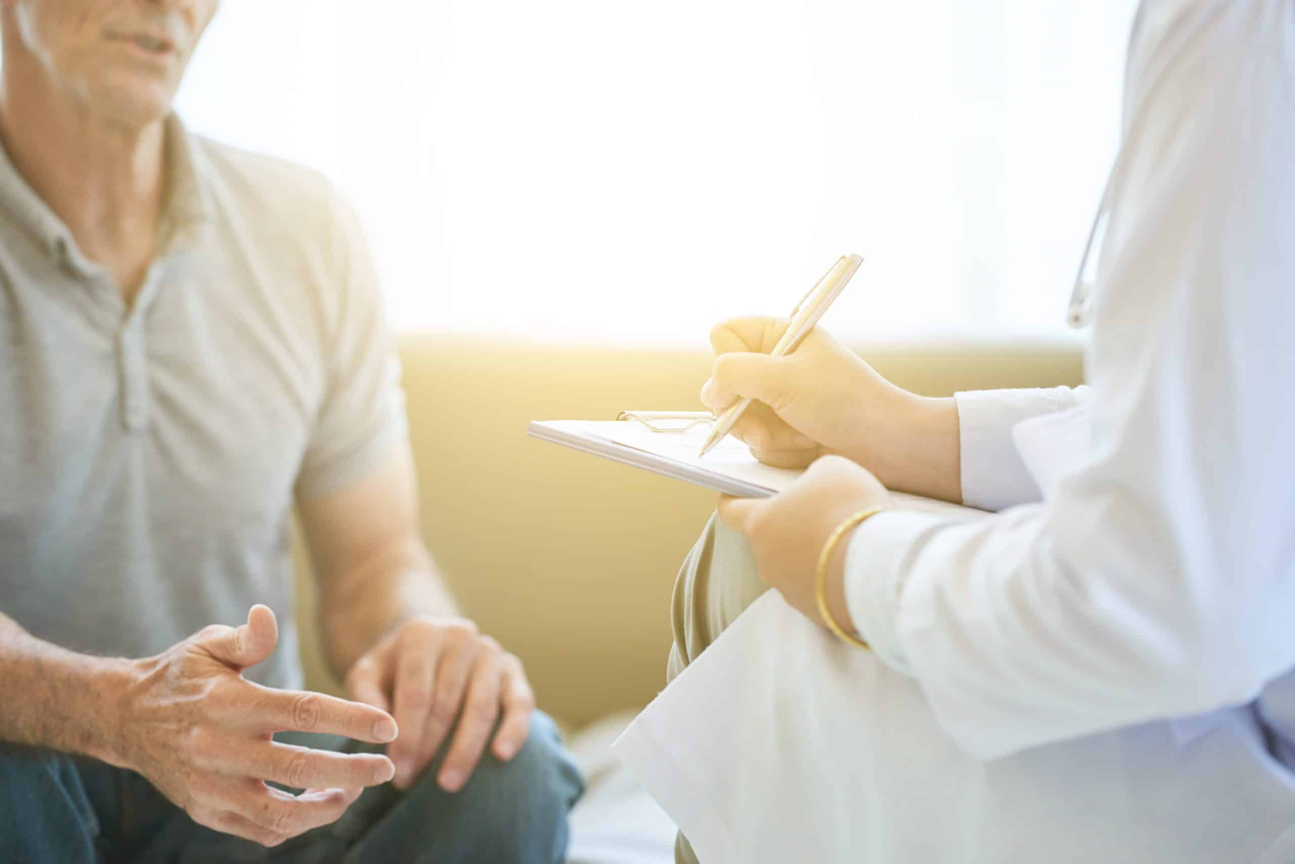man speaks to doctor