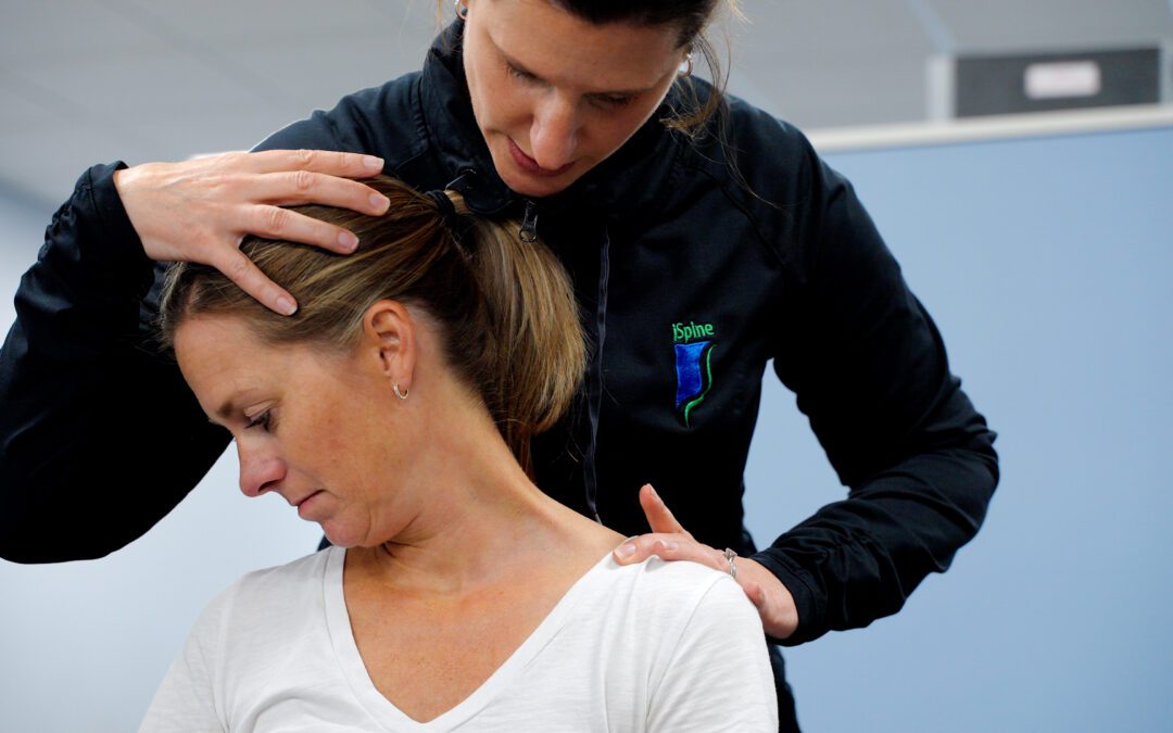 iSpine Rehab therapist doing a manual neck stretch called muscle release technique on a patient