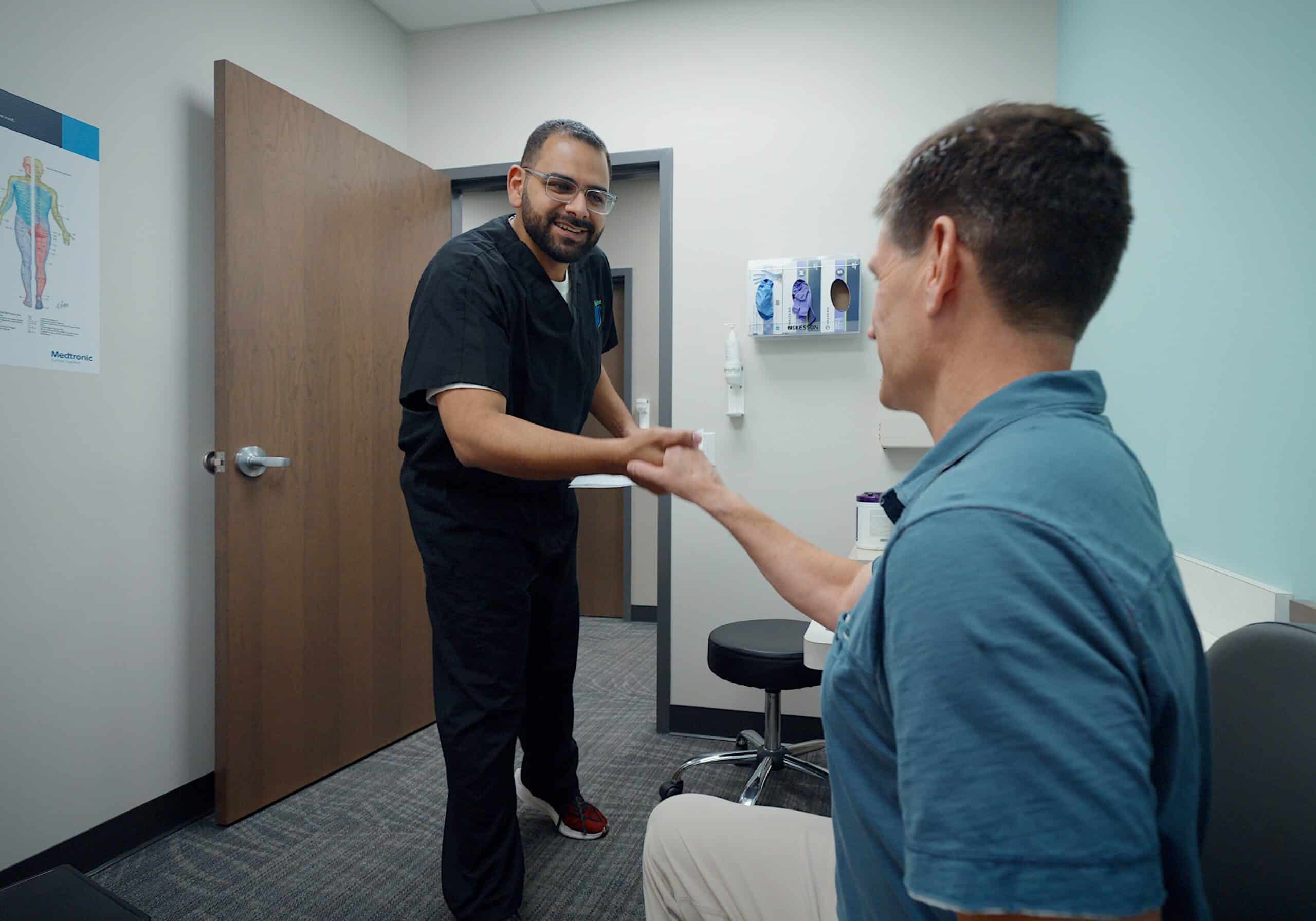 Dr Faltas iSpine Clinics meeting patient with chronic pain in Edina, Minnesota