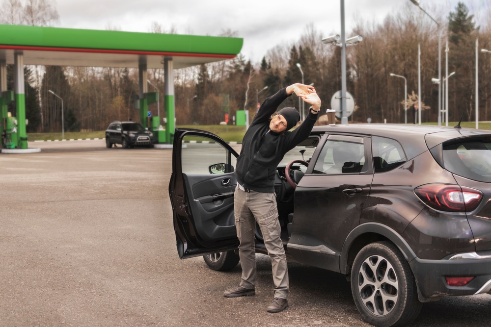 man stretching during car ride to prevent back pain